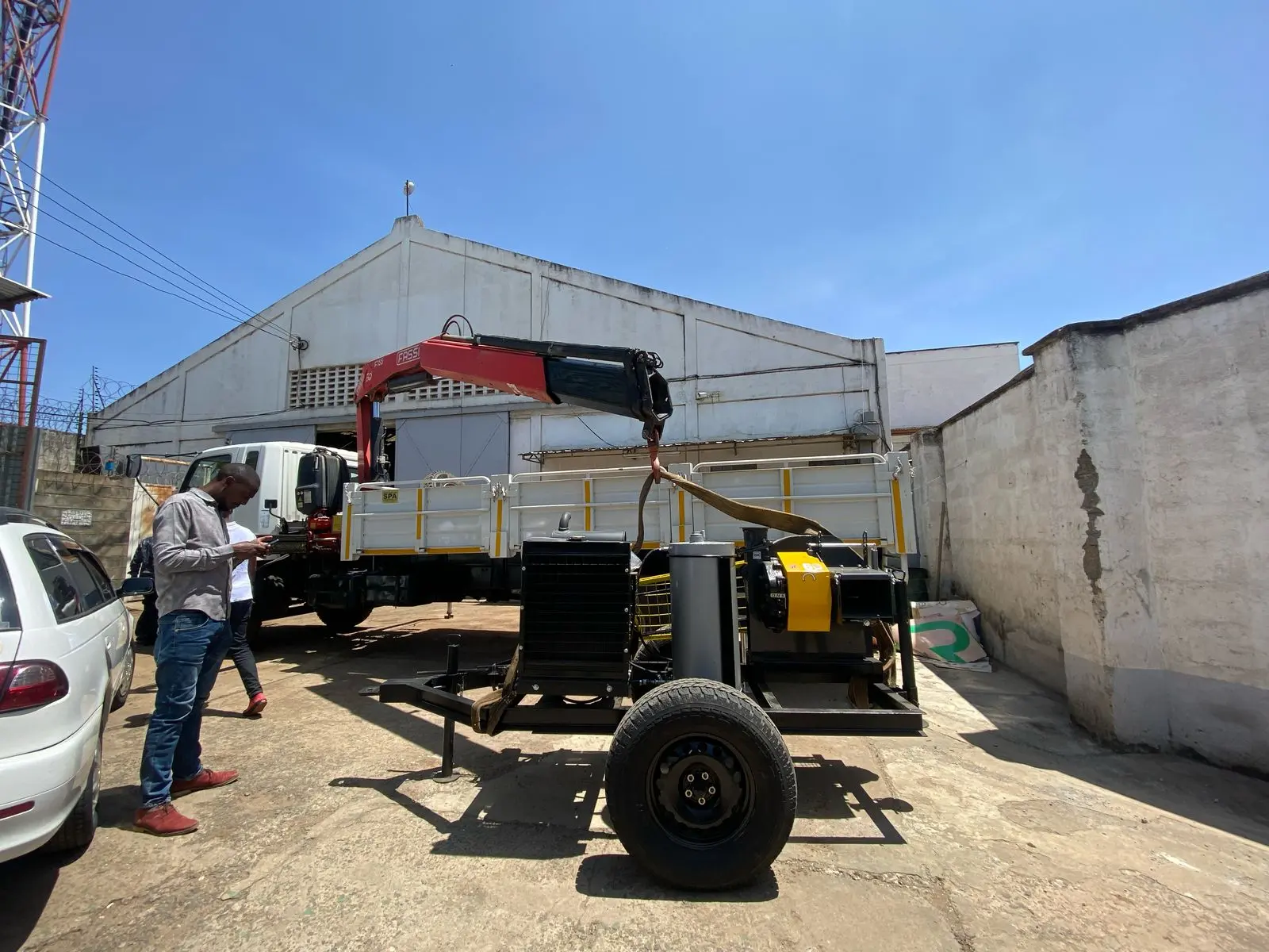 Machine being loaded onto a truck outside Rift Valley Machinery offices