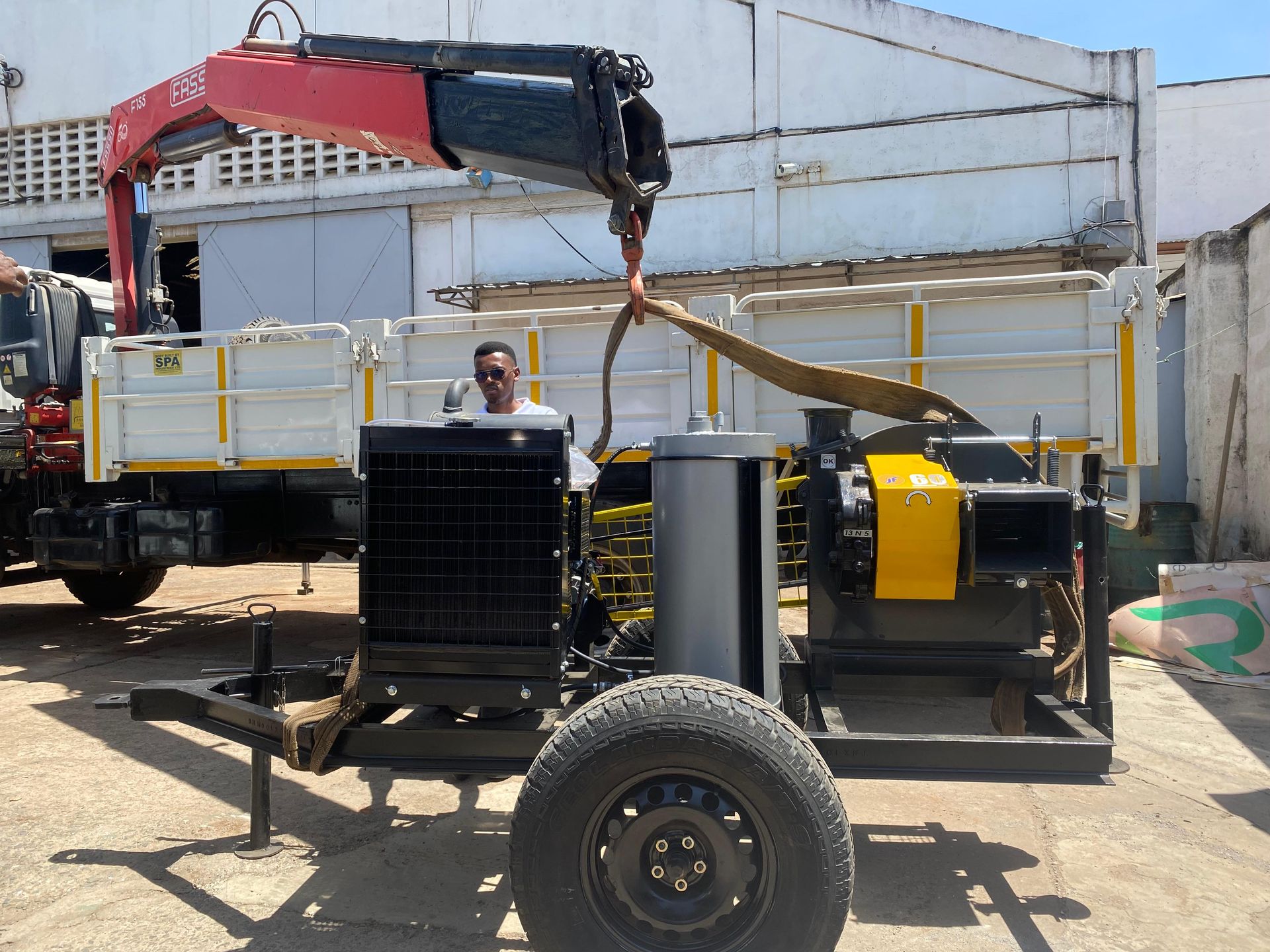 Machine being loaded onto a truck outside Rift Valley Machinery offices