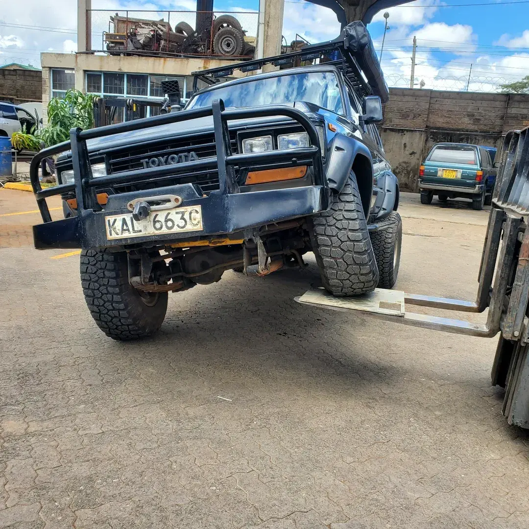 A car is lifted on top a forklift by staffers at RAC 4WD along Mombasa Road